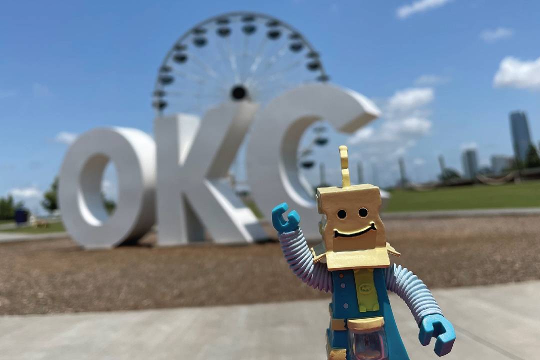 Save-A-Tron in front of an OKC sign