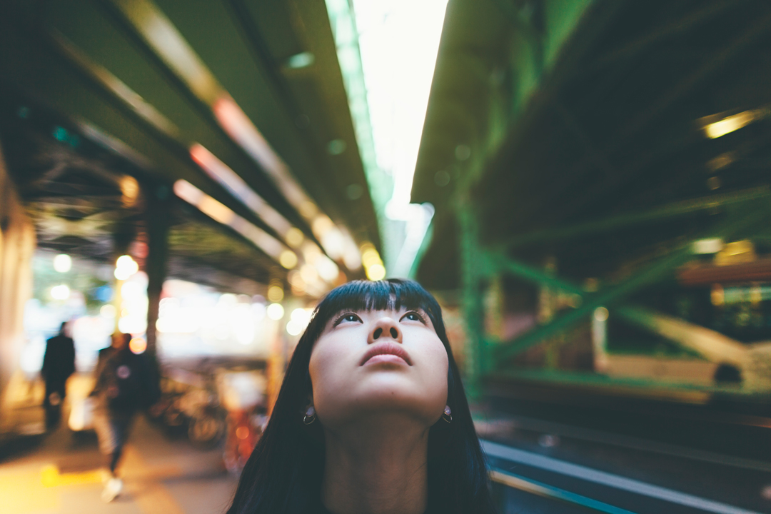 Close up of young woman looking up.