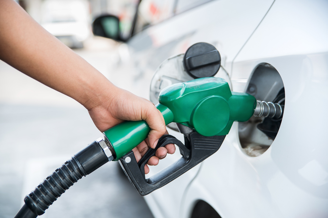 Close up of woman's hand using gas pump