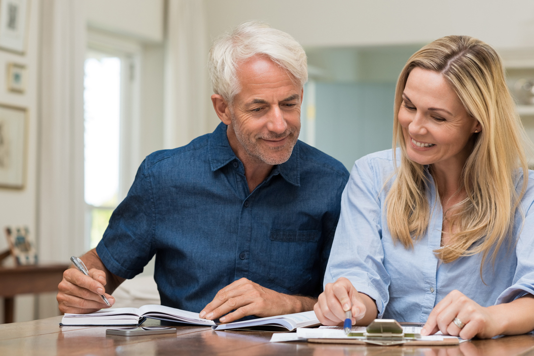 Older man and woman discussing finances