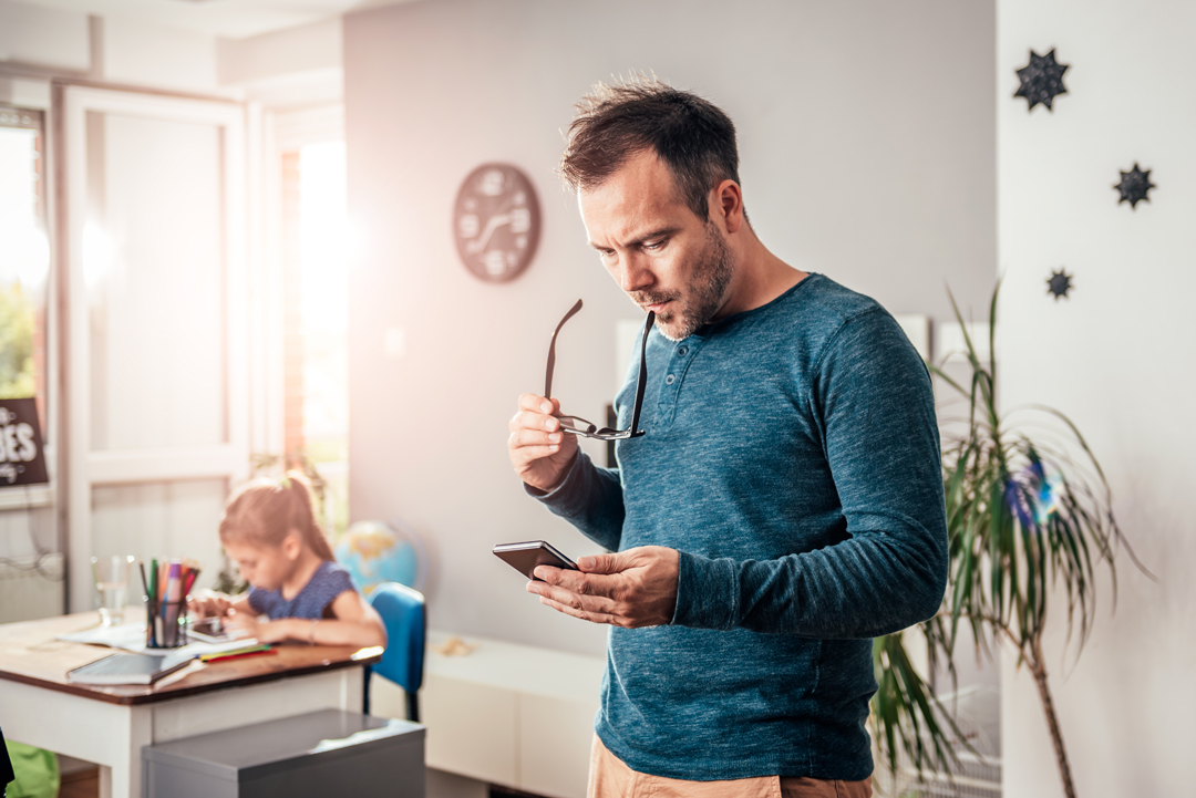 Father shopping for back to school on mobile device