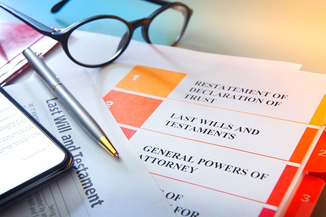 Paperwork with glasses, a pen and a mobile device on it