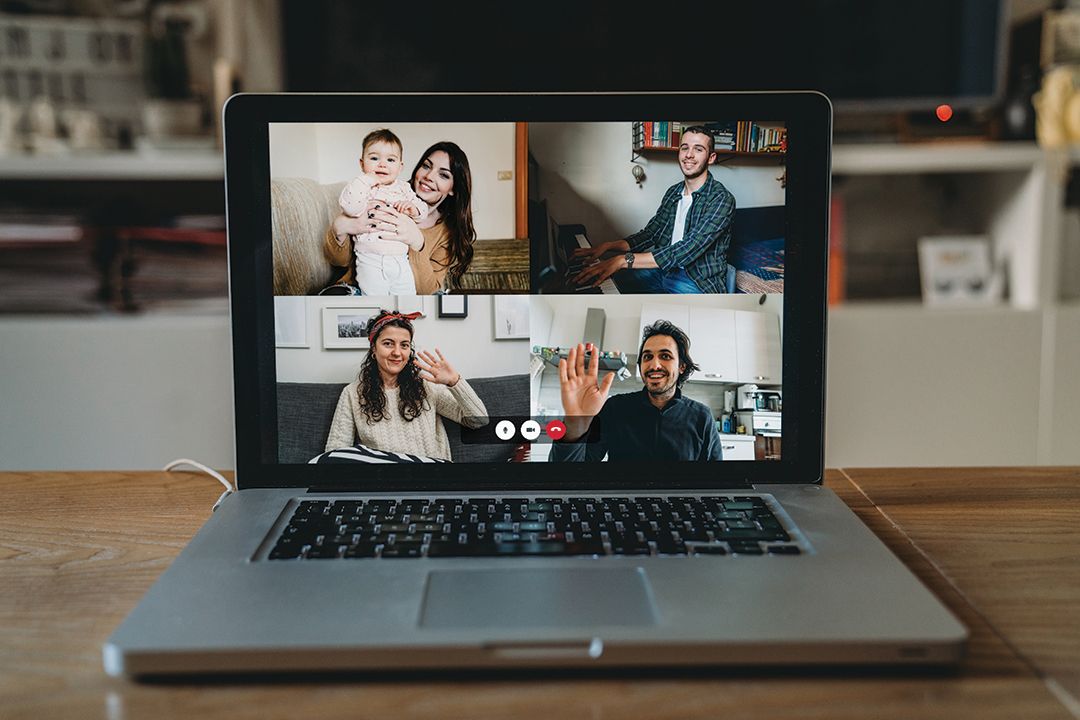 A laptop with people meeting online