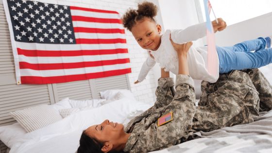 An active duty military mother plays with her daughter