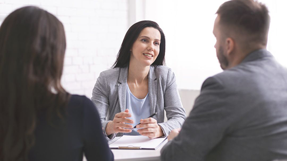 A TFCU representative sits at her desk helping members with their accounts.