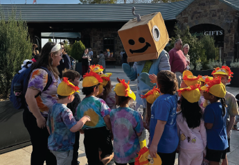 Save-a-tron highfiving a group of kids.