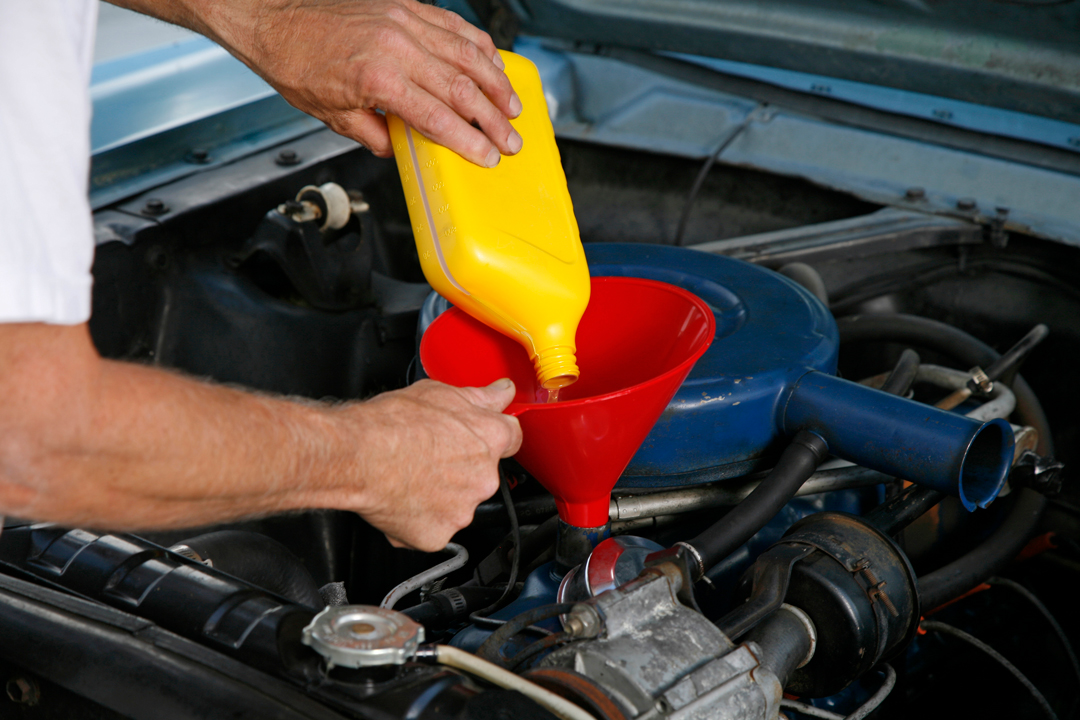 Man changing the oil in the vehicle